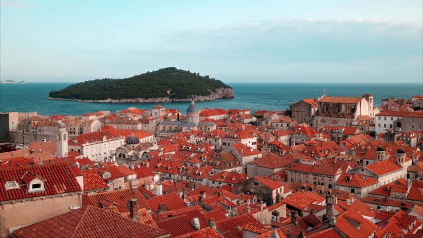 DUBROVNIK, CROATIA – Hyperlapse of Old Town rooftops and Lokrum Island. Historic red tiles and Cathedral dome overlooking the Adriatic Sea on a sunny day.