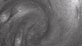 Mesmerizing close-up of silver paint swirling continuously to form a deep vortex while glittering particles flow and rotate to reveal a metallic sandy texture on abstract background - Powered by Shutterstock - Get 15% off with code: PIKWIZARD15