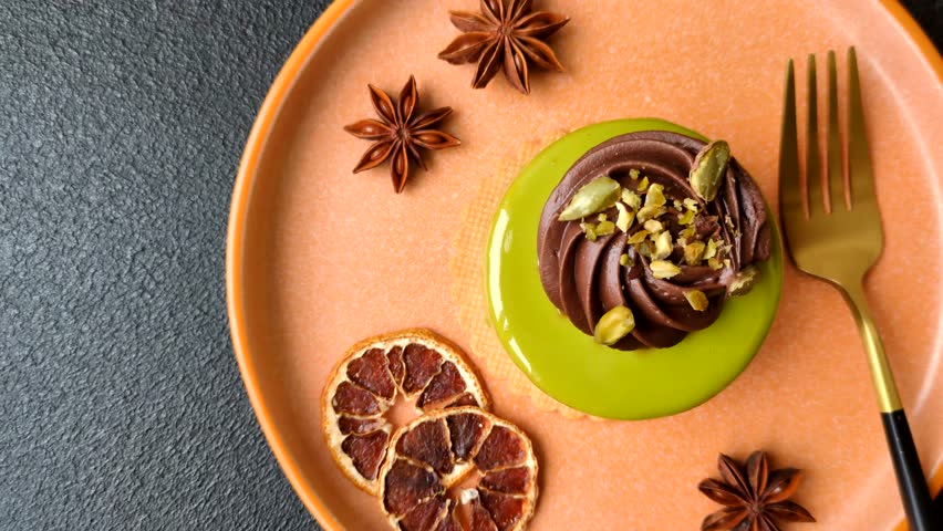 Pistachio cake or tart topped with green mousse with nuts and fruit filling. Pistachio pie