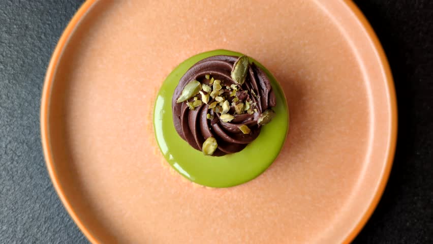 Pistachio cake or tart topped with green mousse with nuts and fruit filling. Pistachio pie