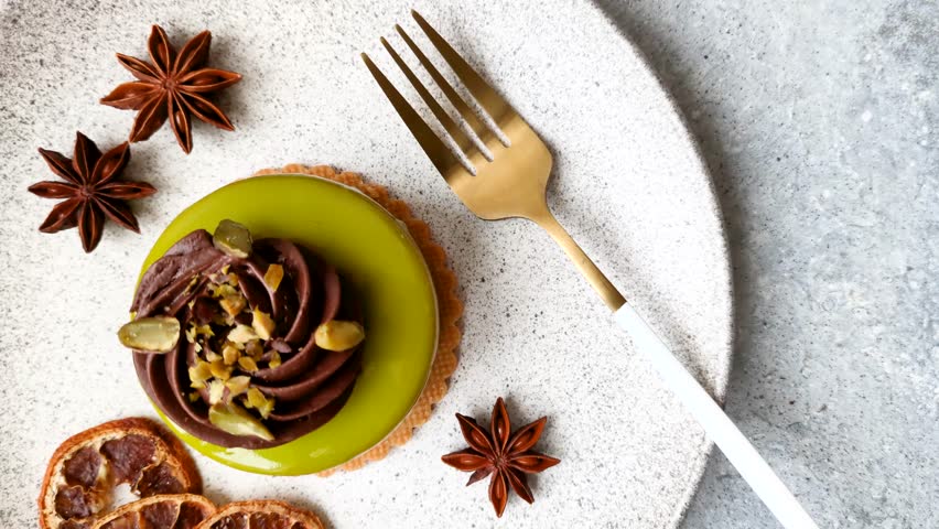Pistachio cake or tart topped with green mousse with nuts and fruit filling. Pistachio pie
