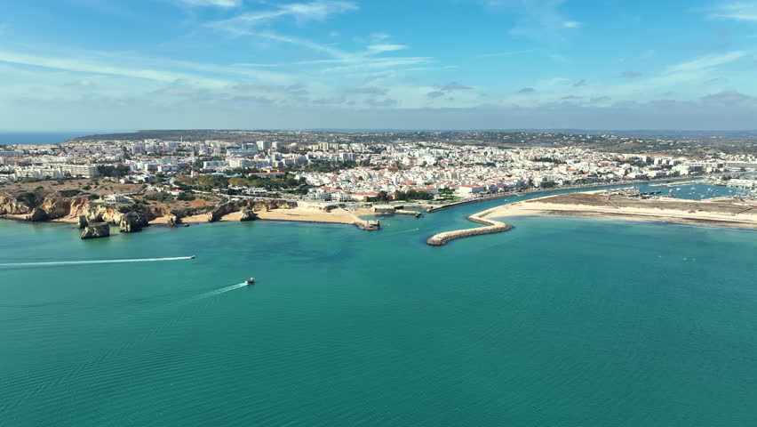A European historic coastal city beside the sea, showing urban structure, waterfront and surrounding landscape