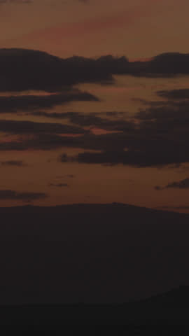 Wide panoramic sunset with golden sun dipping below horizon, painting sky in warm orange and pink tones, peaceful landscape background, cinematic nature scenery at dusk atmosphere glow