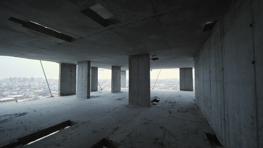 Unfinished concrete building interior with columns
