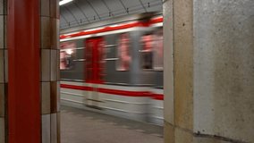 A cinematic video scene captures a metro train moving smoothly between rows of massive station columns. The repeating vertical supports create a strong architectural rhythm, while the train’s motion introduces speed and direction into the structured underground space. Light reflections glide across metal surfaces and column edges, enhancing depth and perspective. The alignment of columns guides the viewer’s eye along the track, reinforcing symmetry and spatial order. The scene highlights the interaction between movement and static architecture, conveying efficiency, routine, and engineered precision. This footage represents themes of urban mobility, underground transport systems, daily commuting, and the visual language of public infrastructure. It is well suited for concepts related to metro systems, architectural interiors, mass transit, city movement, modern transport design, and rhythmic motion in built environments. - Powered by Shutterstock - Get 15% off with code: PIKWIZARD15