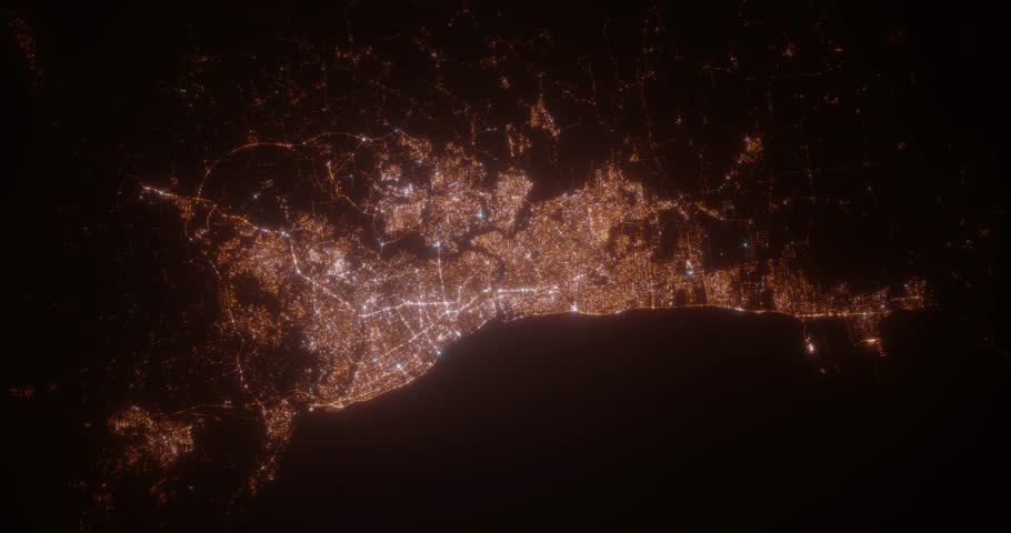 Santo Domingo (Dominican Republic) aerial view at night. View on modern city from space. Camera is zooming in, rotating counterclockwise