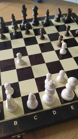 Cinematic shot of a hand positioning a white knight during a chess match