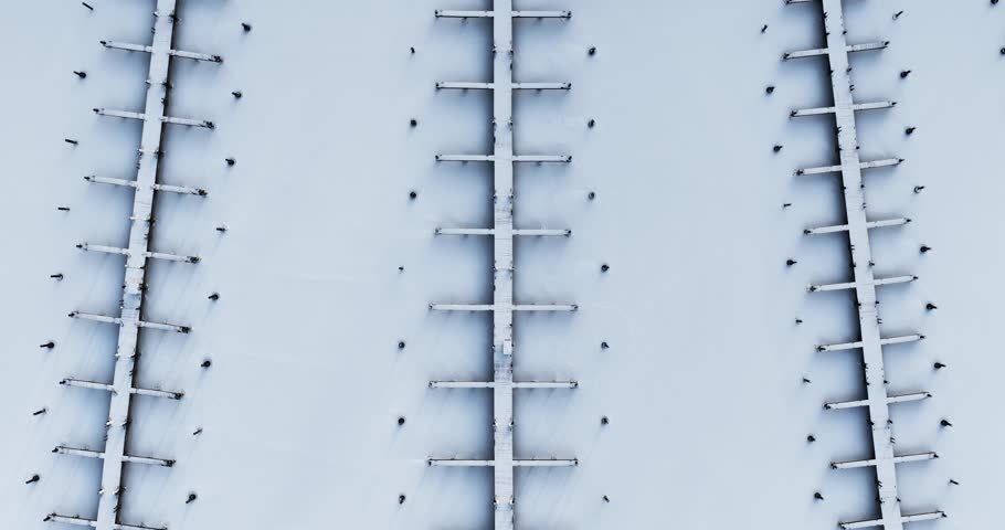 Ithaca, NY, USA. 01-24-2026  Winter aerial video of frozen, snowy marina, docks at Allan H Treman State Marine Park,