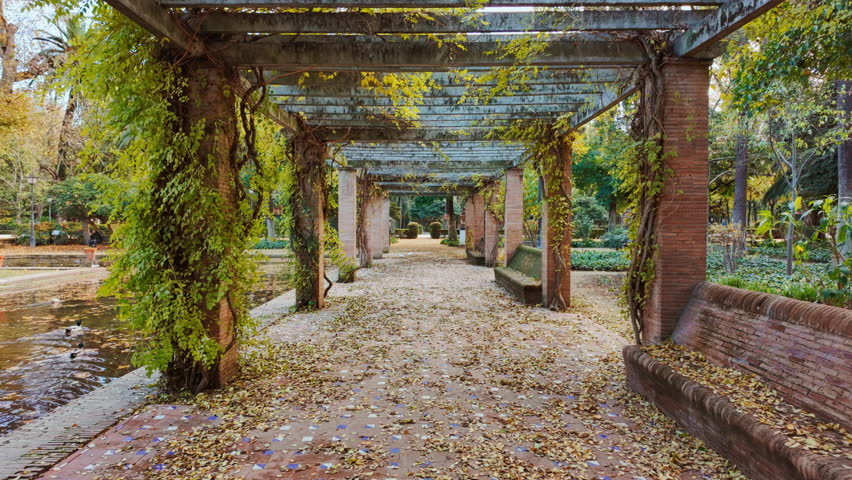 A beautiful pergola at Parque de Maria Luisa, Seville, Andalusia, Spain, expansive lush park with gardens, fountains and monuments
