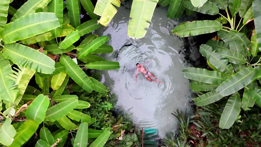 Aerial Top View of Man Floating in Fervedouro do Ceiça Crystal Clear Springs, Jalapão, Brazil