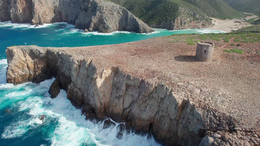 Majestic aerial view of the ancient Spanish tower of Cala Domestica on the Sardinian coast