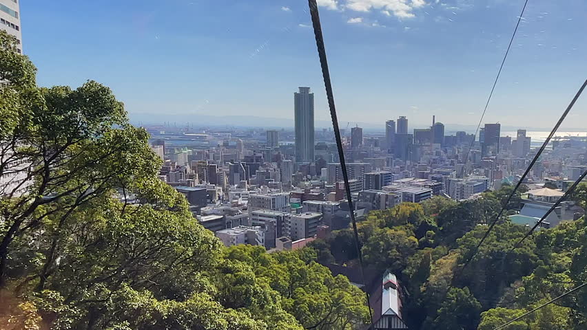 POV: Descending ropeway through trees to bottom station in Kobe, Japan