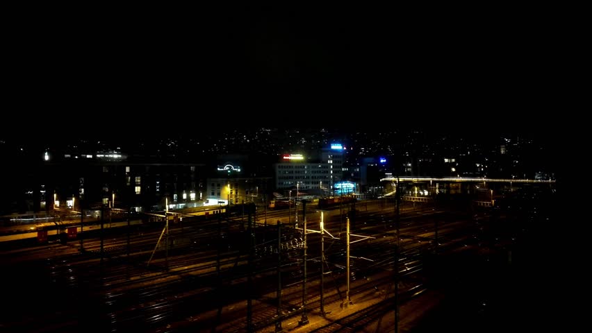 Nighttime Urban Train Station with City Lights.