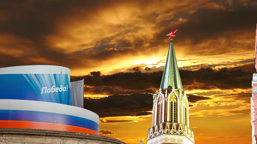 Moscow Kremlin (with decorations for the holiday of May 9 in honor of Victory Day celebration (WWII). Against the sunset, Russia. TRANSLATION: Victory!. time lapse, zoom 