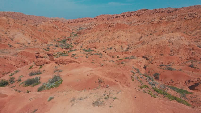 High-speed FPV run through Skazka Fairytale Canyon, carving around sunlit sandstone towers and sculpted cliffs.