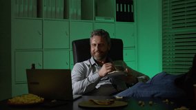 Businessman eats a late-night snack while working on laptop. A tired employee using laptop on late-night overtime. Business man overworked into the night. Freelancer eat pizza late at night. - Powered by Shutterstock - Get 15% off with code: PIKWIZARD15