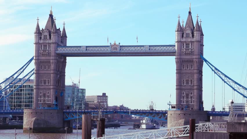 Iconic bridge spanning the River Thames in London, captured on 18 June 2024. Historic architecture stands against a clear blue sky as calm river water reflects the urban landmark scenery, highlighting British heritage, city infrastructure, and bright daytime atmosphere for commercial use.