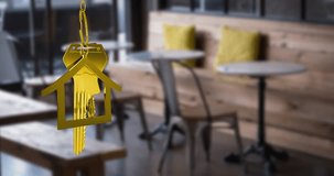 Animation of hanging golden house keys against interior of a cafe. Interior designing and real estate concept - Powered by Shutterstock - Get 15% off with code: PIKWIZARD15