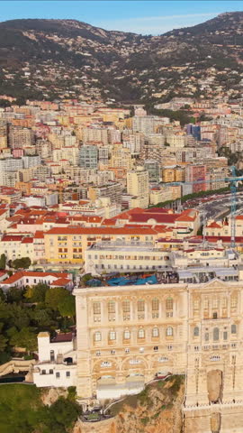 Aerial Vertical Cityscape Golden Hour Over Facades, Hillside Skyline And Coastal Bay Drone Sweeps Across Ornate Palace. Monaco