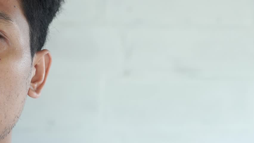 Man showing hand to ear gesture on white background, closeup. Space for text