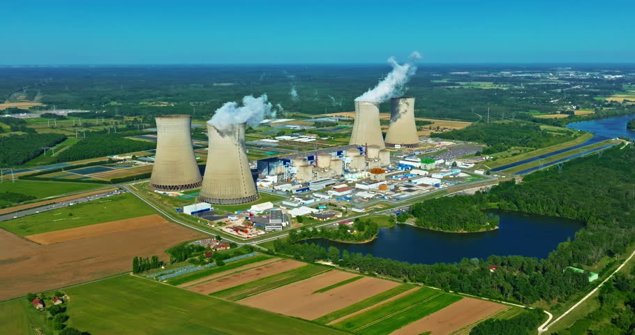 Aerial view of nuclear power plant along a river at summertime
