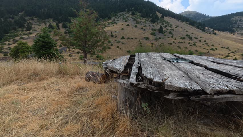 Old Wooden Round Table Made From Logs In Alpine Meadow During Rainy Autumn