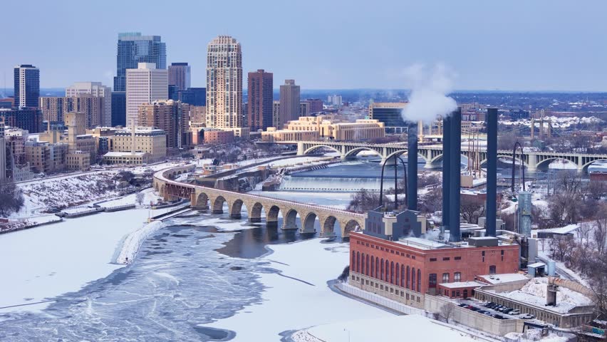 University of Minnesota Southeast Steam Plant and historic Stone Arc Bridge over the Mississippi river in Minneapolis, Minnesota