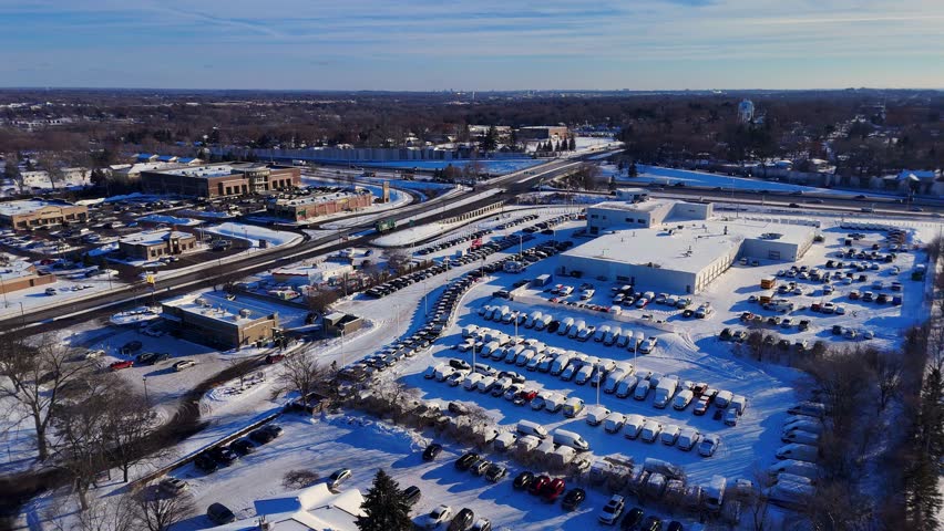Minneapolis, Minnesota suburban landscape with car lots under winter snow