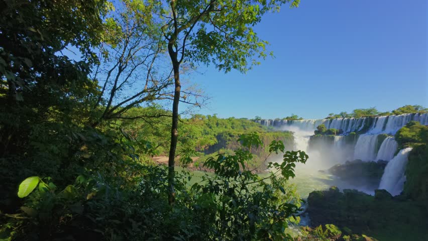 Wide view of Iguazú Falls and Salto San martin cascading into the river seen from Argentina side, lower circuit in Iguazu National park