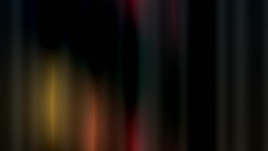 Abstract background with dynamic, glowing golden, orange, red, and blue diagonal light streaks. Soft-focused lines create a futuristic motion blur effect on a dark backdrop, perfect for technology