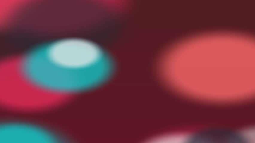 Vibrant abstract bokeh circles in shades of red, orange, and blue on a deep maroon background, forming a soft, blurred texture perfect for overlays, design elements, or festive backdrops