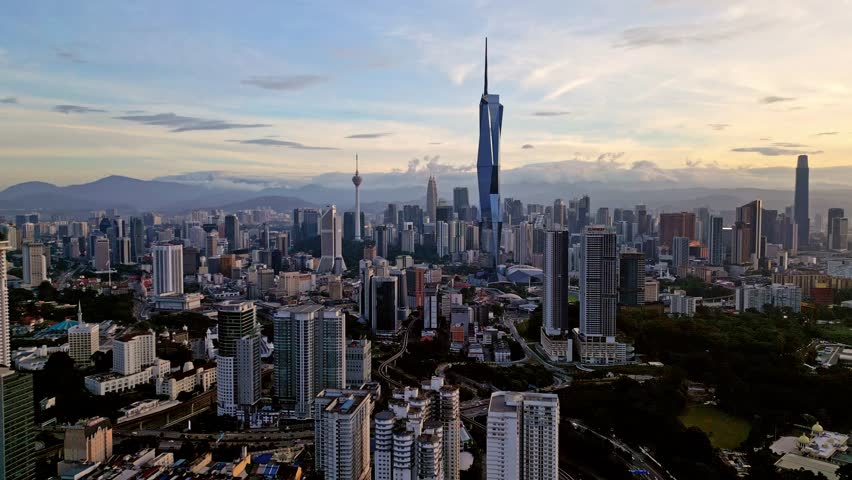 Aerial view of high-rise buildings, including KL Tower and Merdeka 118, contrasting with the lush greenery, Kuala Lumpur, Federal Territory of Kuala Lumpur, Malaysia.