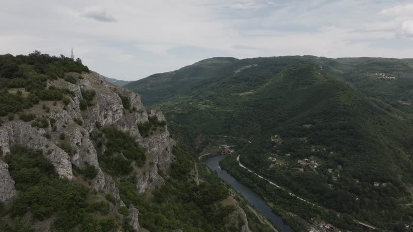 Aerial view of hilly landscape with rocks in foreground.