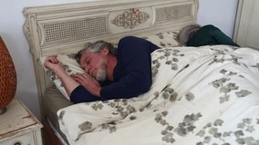 Senior woman suffering from insomnia, feeling restless and agitated while her husband is sleeping peacefully. Couple having sleeping problems - Powered by Shutterstock - Get 15% off with code: PIKWIZARD15