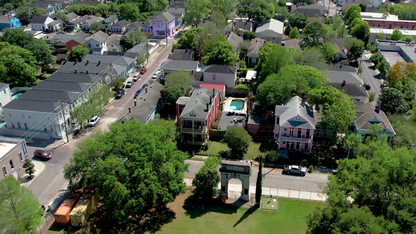 Aerial view of houses, streets, and lush greenery, with buildings displaying vivid colors and architecture, creating a vibrant cityscape, New Orleans, Louisiana, United States.