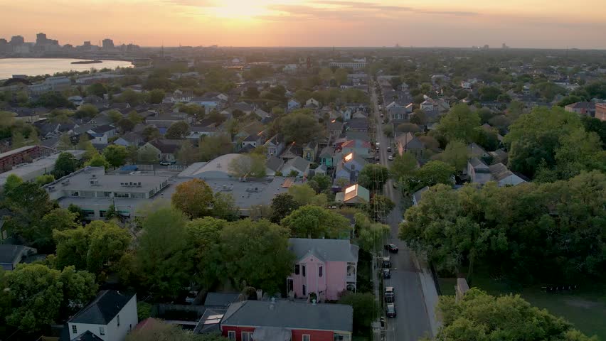 Aerial view of a vibrant cityscape meeting the tranquil suburbs under a serene sky, creating a captivating contrast, New Orleans, Louisiana, United States.