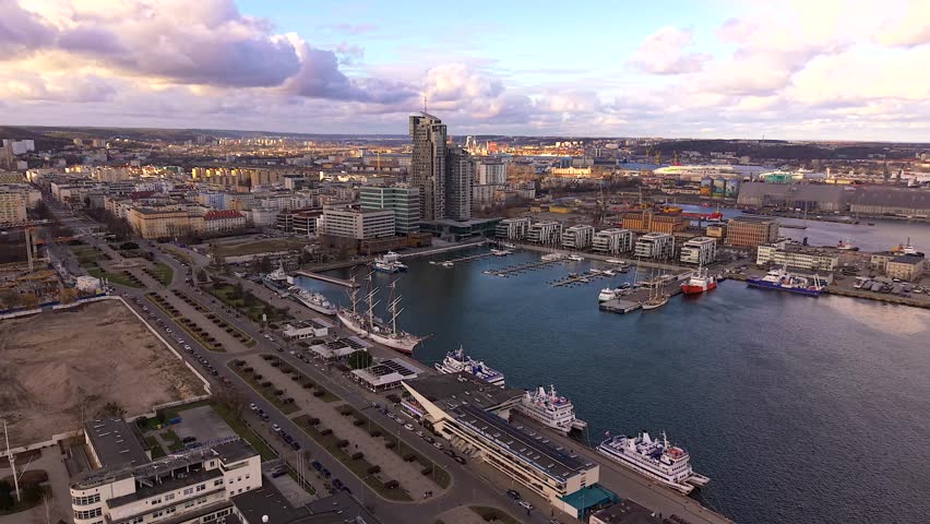 Aerial view of the bustling port in Gdynia with the iconic Sea Towers piercing the skyline, a vibrant tapestry of urban life, Gdynia, Wojewodztwo pomorskie, Poland.