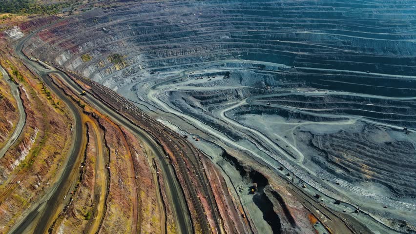 Iron ore mining, mineral deposits, excavation work, drone view.