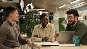 Diverse colleagues collaborating on a business project in a modern coworking space. Young professionals discussing ideas using a laptop - Powered by Shutterstock - Get 15% off with code: PIKWIZARD15