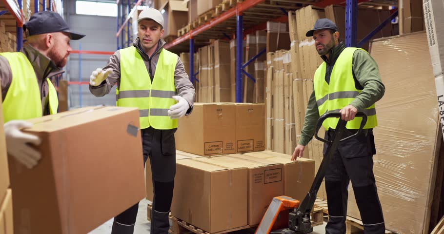 Workers warehouse loading boxes pallet trolley manual. Team in vests uses a pallet trolley near shelving for picking, supporting shipping and delivery. Clean and safe logistics concept.