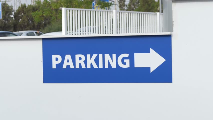 Clear Signage For Drivers, Outdoor Parking Sign With Directional Arrow, Minimalist Blue Parking Sign With White Wall Background, Bright Blue Parking Indicator With Arrow Instructions Driver Navigation