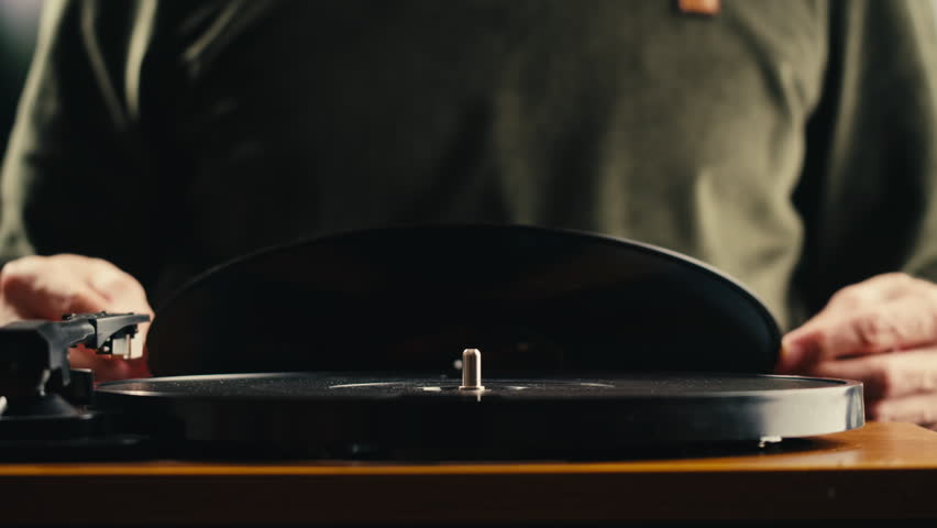 Retro Vinyl record player playing music, needle close-up macro shot of vintage LP disc old phonograph spinning. Retro music player at home.