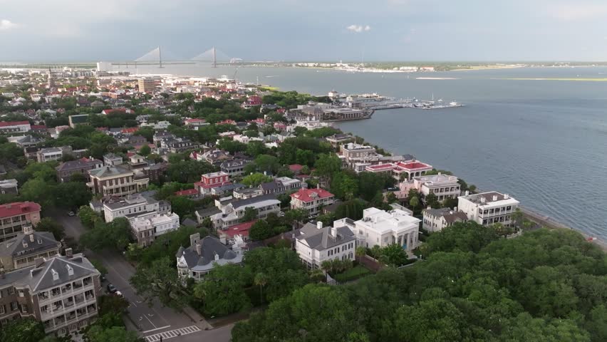 Panoramic Aerial view of Charleston, South Carolina cityscape skyline showing lowcountry landscapes and south of broad neighborhood with historic homes and mansions along waterfront - 4K Drone