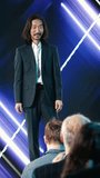Vertical Video Asian chief product officer does new product presentation for mobile technology, modern design coming soon. Innovation, and marketing with smartphone reveal at launch event in - Powered by Shutterstock - Get 15% off with code: PIKWIZARD15