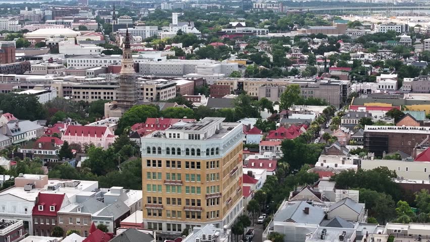 Aerial view of Charleston, South Carolina skyline cityscape landscape with church steeples and downtown historic buildings on Atlantic coast port city - 4K Drone