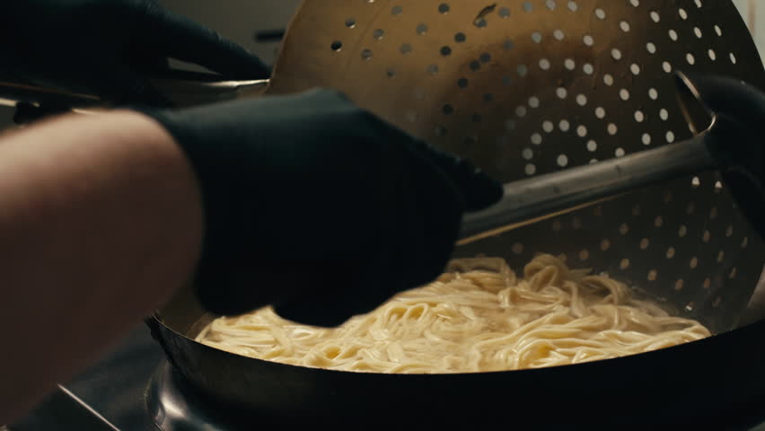 Asian Wok noodles cooking, Chef cooking handmade pasta wok frying pan close-up. Chinese traditional beef and chicken vegetables on fire pan, japanese korean pasta. Restaurant Food concept. Sea food.