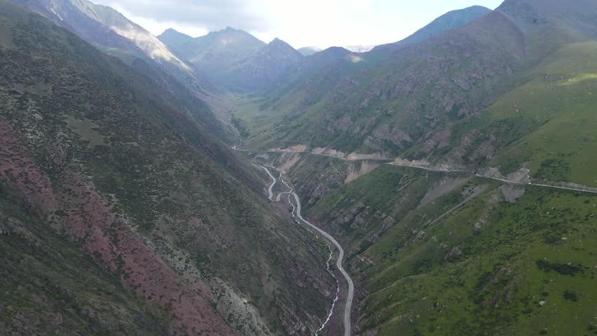 road in a mountain gorge. serpentine roads. mountain peaks. summer in the mountains