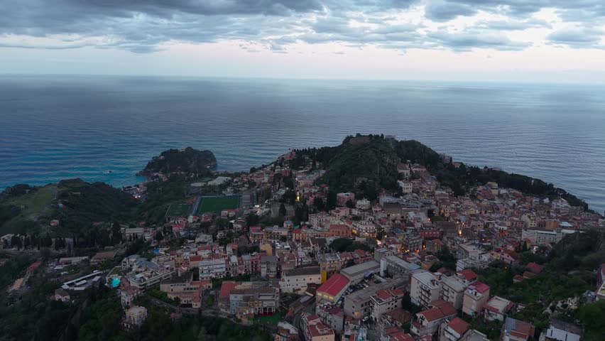 Aerial View Of Castelmola Comune And Ionian Sea At Dusk In Sicily, Italy. - pullback shot