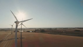 Wind turbines in a field generating renewable energy, sustainable power, eco-friendly technology, clean energy concept, and green environment landscape. - Powered by Shutterstock - Get 15% off with code: PIKWIZARD15
