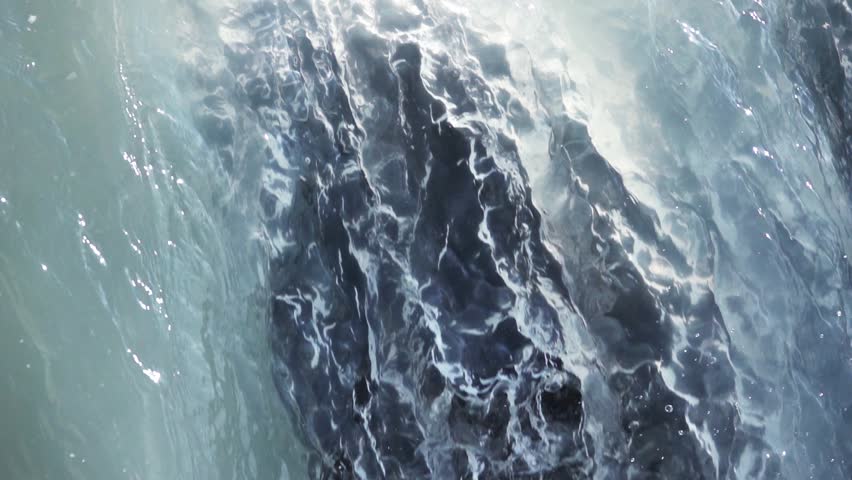 Close-up of a waterfall with cascading water, capturing nature’s beauty, motion, and tranquil landscape scenery.